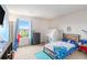 Cozy bedroom featuring neutral walls, a window, and a play tent beside the bed at 3350 Clawing Hawk Way, Douglasville, GA 30135