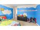 Charming bedroom with cloud-painted blue walls and playful decor elements at 3350 Clawing Hawk Way, Douglasville, GA 30135