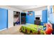 Bright bedroom with blue accent walls, a closet, and a window offering natural light at 3350 Clawing Hawk Way, Douglasville, GA 30135