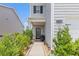 Inviting front porch and walkway with garden bed leading to the home's front door at 3350 Clawing Hawk Way, Douglasville, GA 30135