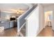 Open hallway with wood floors, stairs to the upper level, and a view into the adjacent living room at 3350 Clawing Hawk Way, Douglasville, GA 30135