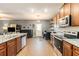 Open kitchen boasts stainless appliances, granite counters and wood floors at 3350 Clawing Hawk Way, Douglasville, GA 30135