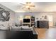 Cozy living room with laminate floors, ceiling fan, and modern decor with lots of natural light at 3350 Clawing Hawk Way, Douglasville, GA 30135
