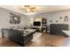 Comfortable living room with a large sofa, entertainment center, ceiling fan, and wood laminate flooring at 3350 Clawing Hawk Way, Douglasville, GA 30135