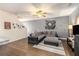 Inviting living room features wood floors, ceiling fan and comfortable gray sectional sofa at 3350 Clawing Hawk Way, Douglasville, GA 30135