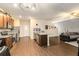Open floor plan featuring kitchen island, wood floors, stainless dishwasher and cozy living room at 3350 Clawing Hawk Way, Douglasville, GA 30135