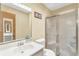 Bathroom with a white sink, toilet and shower stall with sliding glass doors at 400 Little John Nw Dr, Lilburn, GA 30047