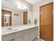 Well-lit bathroom featuring a large mirror, white countertop, and neutral color scheme at 400 Little John Nw Dr, Lilburn, GA 30047