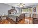 Primary bedroom features a decorative dark-wood bed frame and matching side tables at 400 Little John Nw Dr, Lilburn, GA 30047
