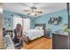 Stylish bedroom featuring unique decor, modern furniture, and a vibrant blue accent wall at 400 Little John Nw Dr, Lilburn, GA 30047