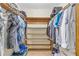 Walk-in closet featuring custom wooden shelving for optimal organization and storage at 400 Little John Nw Dr, Lilburn, GA 30047