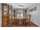 Elegant dining room features a classic wood table with seating for eight and decorative china cabinet at 400 Little John Nw Dr, Lilburn, GA 30047