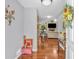 Inviting foyer with hardwood floors leading into a living area with fireplace and TV at 400 Little John Nw Dr, Lilburn, GA 30047