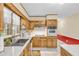 Bright kitchen with oak cabinets and modern appliances offers a functional cooking space at 400 Little John Nw Dr, Lilburn, GA 30047