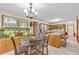 Bright eat-in kitchen area adjacent to stainless steel fridge and oak cabinets at 400 Little John Nw Dr, Lilburn, GA 30047