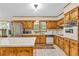 Traditional kitchen with tiled floors, stainless steel fridge and wood cabinetry at 400 Little John Nw Dr, Lilburn, GA 30047