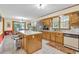 Kitchen has an island, tiled floors, and an adjacent dining area with sliding doors at 400 Little John Nw Dr, Lilburn, GA 30047