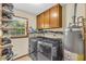 Functional laundry room equipped with modern washer/dryer units and storage cabinets at 400 Little John Nw Dr, Lilburn, GA 30047