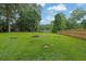 Spacious backyard with mature trees, garden shed, and fire pit at 1031 Washington Ave, Woodstock, GA 30188