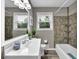 Bathroom with a white sink, a shower with mixed tile and a window with natural light at 1031 Washington Ave, Woodstock, GA 30188