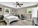 Bedroom featuring a ceiling fan, two windows and a desk with chair at 1031 Washington Ave, Woodstock, GA 30188