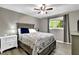 Cozy bedroom with a ceiling fan and ample natural light from the window at 1031 Washington Ave, Woodstock, GA 30188