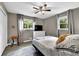 Bedroom with a ceiling fan, closet and dresser with a TV on top at 1031 Washington Ave, Woodstock, GA 30188
