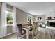 Dining room featuring a modern table, fireplace and a scenic view through sheer curtained windows at 1031 Washington Ave, Woodstock, GA 30188