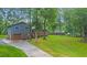 Two-story home with a gray exterior, brick accents, attached garage, a long driveway and a spacious front yard at 1031 Washington Ave, Woodstock, GA 30188