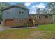 Charming two-story home with a gray exterior, brick accents, an attached garage, and a newly landscaped front yard at 1031 Washington Ave, Woodstock, GA 30188