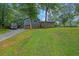 Charming home with lush front yard and driveway at 1031 Washington Ave, Woodstock, GA 30188