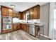 Modern kitchen with warm wood cabinets, granite countertops, and stainless steel appliances at 1031 Washington Ave, Woodstock, GA 30188
