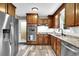 A stylish kitchen featuring stainless steel appliances, wood cabinets and granite countertops at 1031 Washington Ave, Woodstock, GA 30188