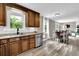 Well-lit kitchen with granite countertops, stainless steel appliances, and wood cabinets at 1031 Washington Ave, Woodstock, GA 30188
