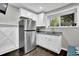 Functional kitchenette with stainless steel refrigerator and granite countertops at 1031 Washington Ave, Woodstock, GA 30188