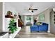 Inviting living room with a decorative fireplace, light filled window, and comfortable blue sofa at 1031 Washington Ave, Woodstock, GA 30188