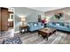 Inviting living room featuring stylish sofas, modern decor, hardwood floors, and plenty of natural light at 1031 Washington Ave, Woodstock, GA 30188