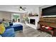 Open-concept living room featuring a cozy fireplace, and sliding glass doors to the outdoor patio at 1031 Washington Ave, Woodstock, GA 30188