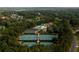 Overhead image of a community with tennis courts and a pool surrounded by lush greenery at 11255 Knollwood Bnd, Johns Creek, GA 30097