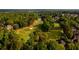 Aerial view of the community featuring mature trees, a golf course, and beautiful homes at 11255 Knollwood Bnd, Johns Creek, GA 30097