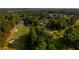 An aerial view of a lovely community, highlighting the golf course and a tranquil pond at 11255 Knollwood Bnd, Johns Creek, GA 30097