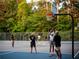 Community basketball court surrounded by lush greenery, perfect for outdoor recreation and staying active at 11255 Knollwood Bnd, Johns Creek, GA 30097