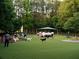 Outdoor dog park featuring a lush green lawn, seating area, and play equipment for furry friends and their owners to enjoy at 11255 Knollwood Bnd, Johns Creek, GA 30097