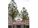 Exterior view of the Regal RPX building with tall trees in front of the facade at 11255 Knollwood Bnd, Johns Creek, GA 30097