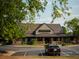 Exterior shot of Stoney River Steakhouse and Grill with parking, framed by trees on a sunny day at 11255 Knollwood Bnd, Johns Creek, GA 30097