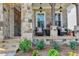Inviting front porch featuring stone pillars, a seating area, and well-maintained landscaping at 11255 Knollwood Bnd, Johns Creek, GA 30097