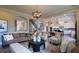 Bright and open living room with neutral tones, hardwood floors, and seamless flow to the kitchen at 11255 Knollwood Bnd, Johns Creek, GA 30097