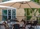 Outdoor seating area with modern tables and chairs under a large umbrella at 11255 Knollwood Bnd, Johns Creek, GA 30097