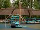 Fun playground with swings, slides, and climbing structures under a large sun shade at 11255 Knollwood Bnd, Johns Creek, GA 30097