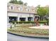 Exterior shot of the shopping center lined with businesses and walkways at 11255 Knollwood Bnd, Johns Creek, GA 30097